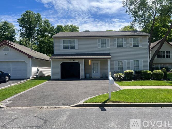 A two-story house with a garage is for sale.