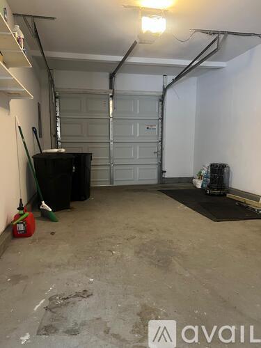 A room with a black piano and a red bag on the floor.