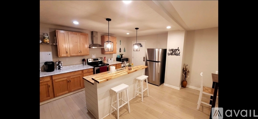 A kitchen with wooden cabinets and a white fridge.