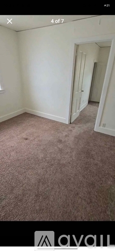 A room with a carpeted floor and white walls.