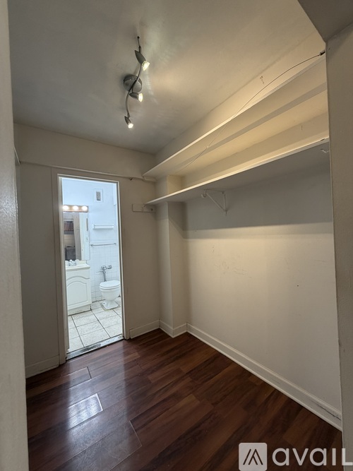 A room with wooden floors and white walls.