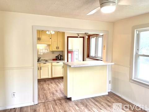 A kitchen with wooden cabinets and a white countertop.