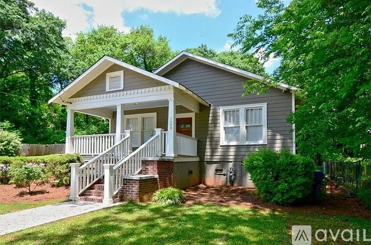 A house with a front porch and a staircase leading to it.