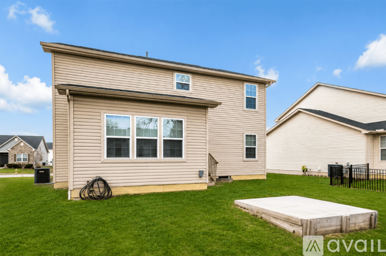 A house with a beige exterior and a white garage door.