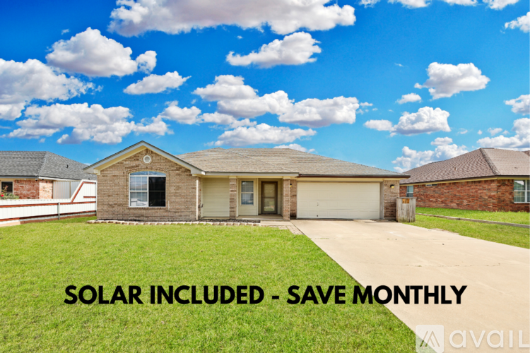 A house with a solar panel system is advertised to save money monthly.