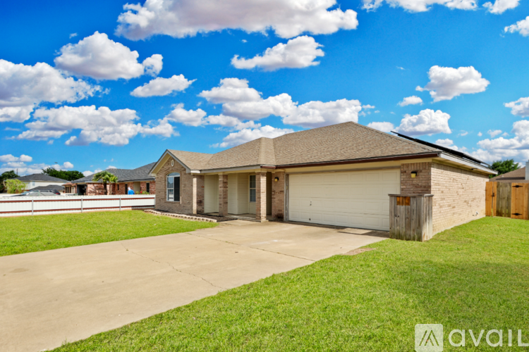 A house with a large front yard and a garage.