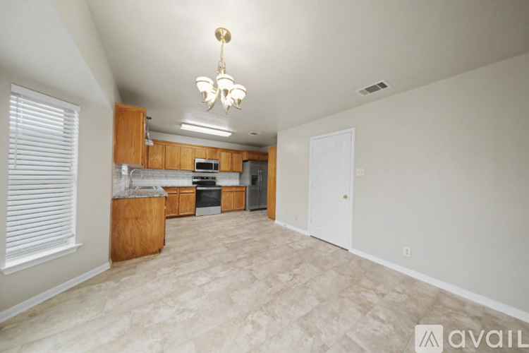 A kitchen area with wooden cabinets and a microwave.