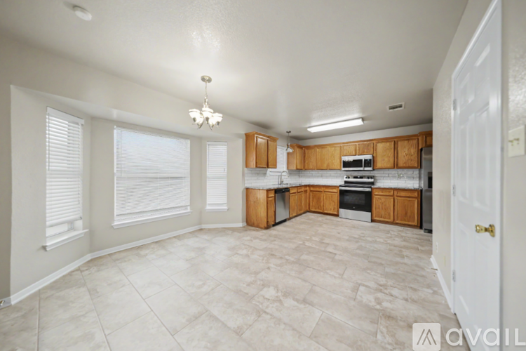 A kitchen with wooden cabinets and a white door.