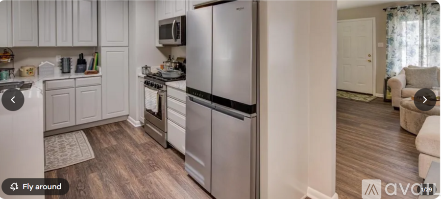 A kitchen with a refrigerator, stove, and microwave.
