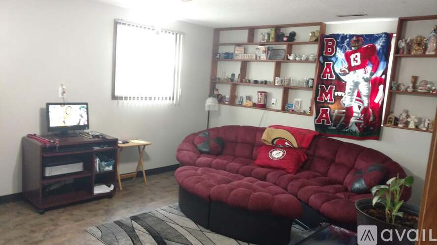 A living room with a red sofa and a television.