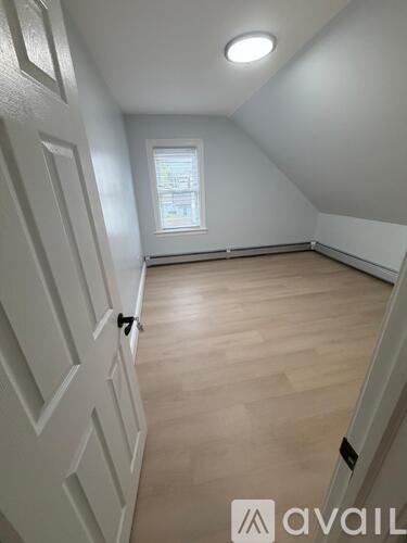 A white door with a black handle is on the left side of the image.
