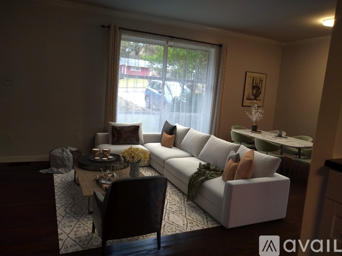 A living room with a white couch and a coffee table.