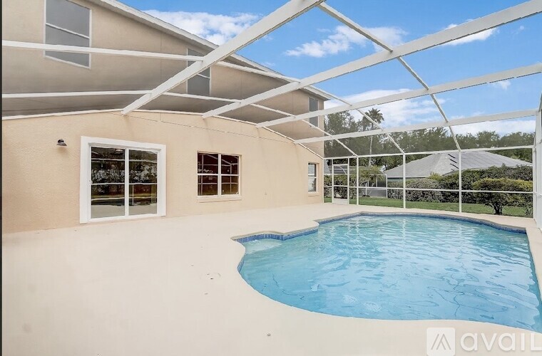 A pool in a house with a glass ceiling.