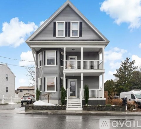 A two-story house with a grey exterior and white trim is available for purchase.