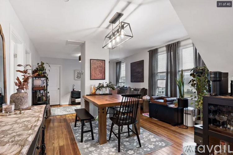 A modern dining room with a wooden table and chairs.