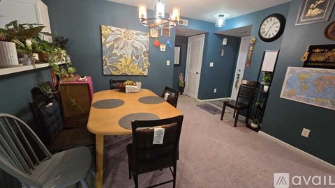 A dining room with a table and chairs.