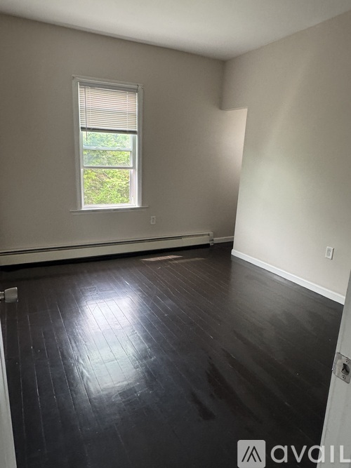 A two-story house with a grey exterior and white trim is available for purchase.