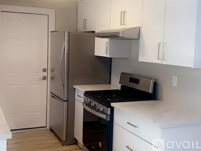 A kitchen with a stainless steel refrigerator, oven, and stove.