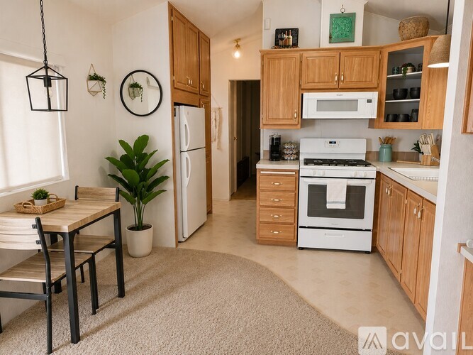 A kitchen with wooden cabinets and white appliances.