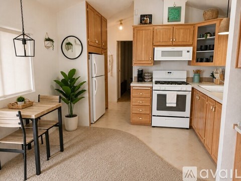 A kitchen with wooden cabinets and white appliances.