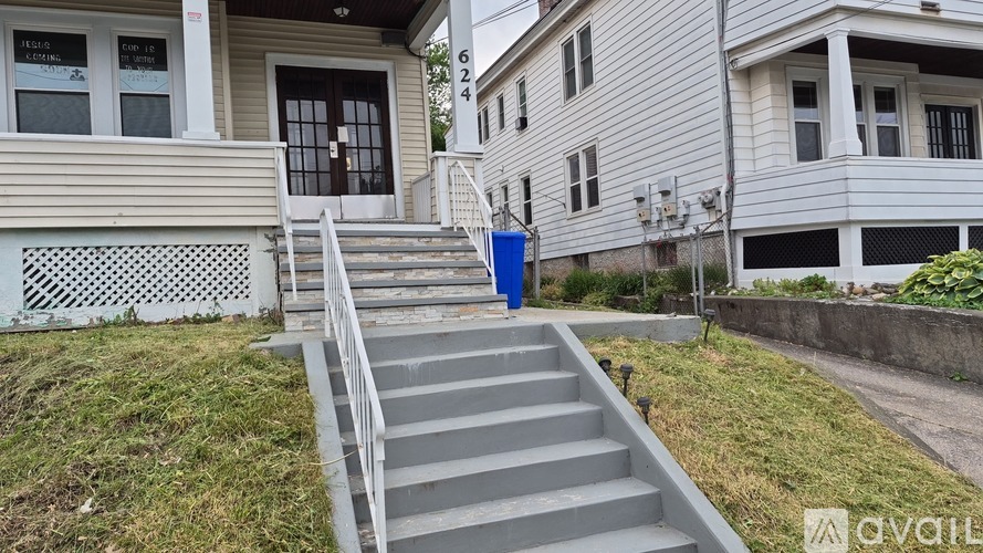 A house with a staircase leading to the front door.