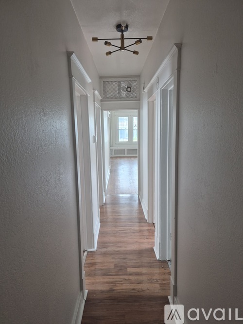 A long hallway with a light on the ceiling and a logo that says "avail" on the bottom right.