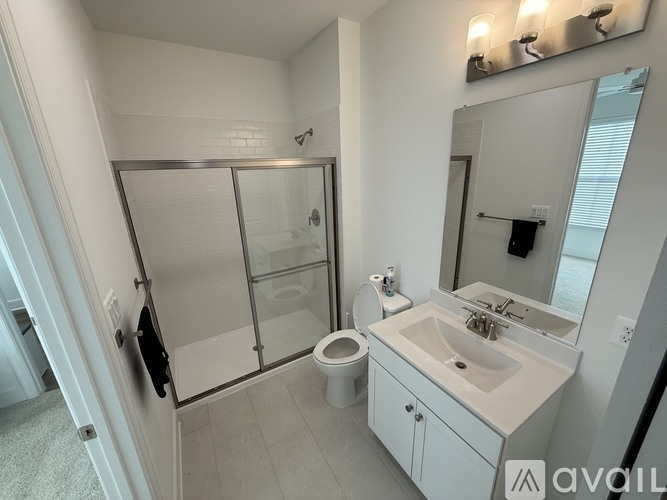 A bathroom with a sink, toilet, and shower.