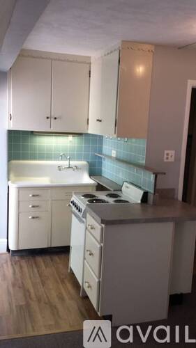 A kitchen with white appliances and cabinets.