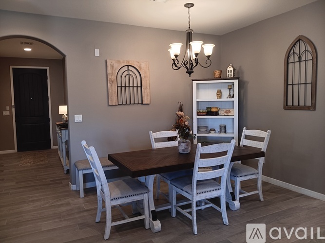 A dining room with a wooden table and chairs.
