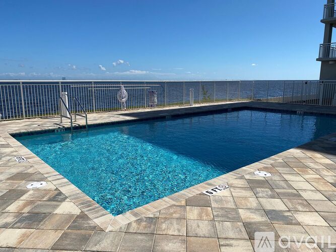 A small rectangular pool with a tiled floor and a metal fence surrounding it.