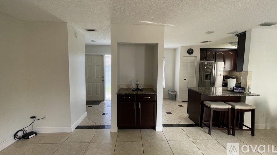 A kitchen with a dining table and chairs is available for rent.