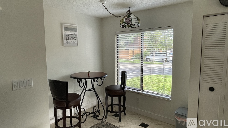 A small dining room with a table and chairs.