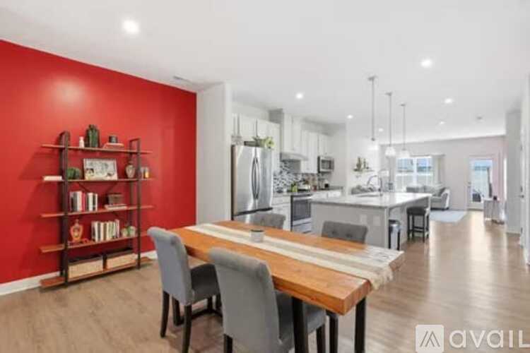 A modern kitchen with a dining table and chairs.