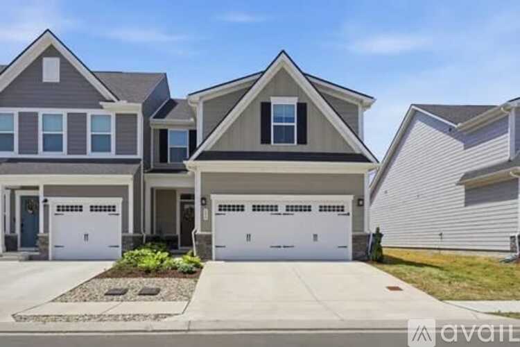 A modern house with a garage is for sale.