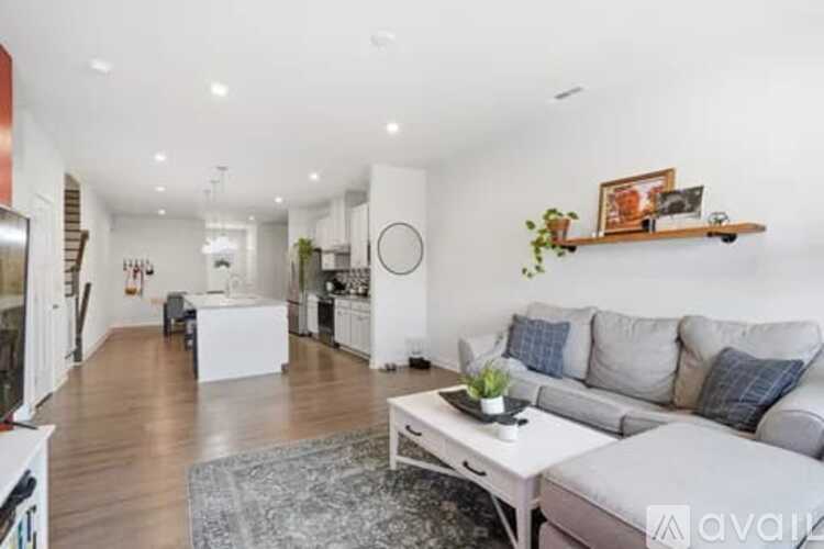 A living room with a grey couch and a white coffee table.