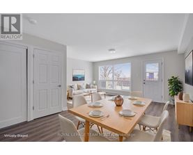 A dining room with a wooden table set for six.