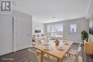 A dining room with a wooden table set for six.
