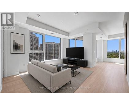 A living room with a large couch and a television set.