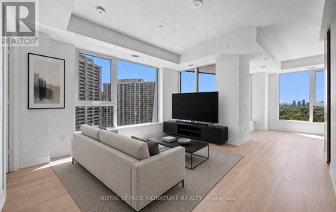 A living room with a large couch and a television set.