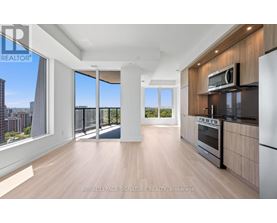 A spacious kitchen with wooden floors and modern appliances.