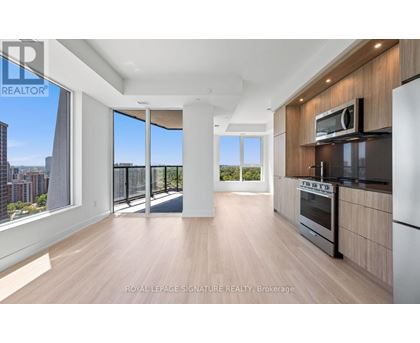 A spacious kitchen with wooden floors and modern appliances.