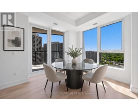 A dining room with a glass table and chairs with a view of the city.