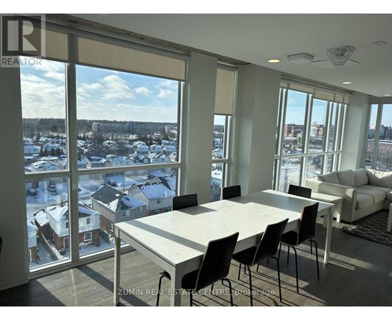 A dining room with a view of a snowy landscape outside.