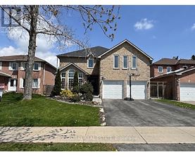 A house with a brown brick exterior and a white garage door.