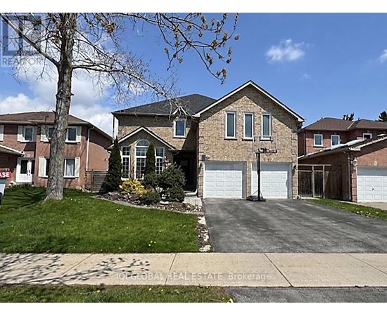 A house with a brown brick exterior and a white garage door.