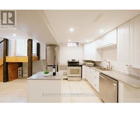 A modern kitchen with white cabinets and appliances.