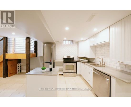 A modern kitchen with white cabinets and appliances.