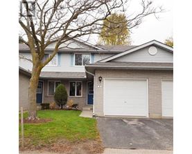 A house with a grey roof and a white garage door.
