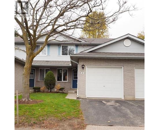 A house with a grey roof and a white garage door.