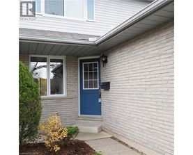 A house with a blue door and a window with white trim.